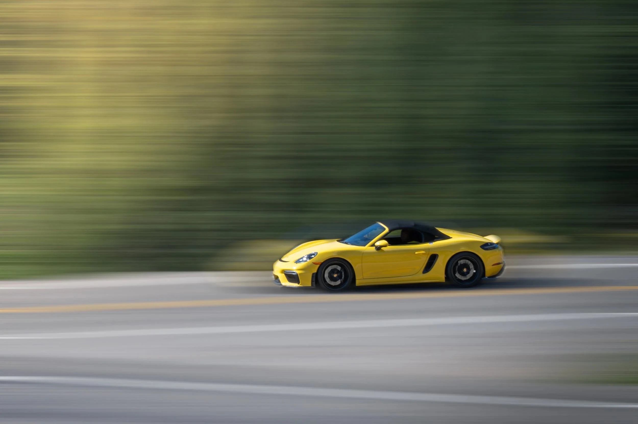A yellow Porsche, panned