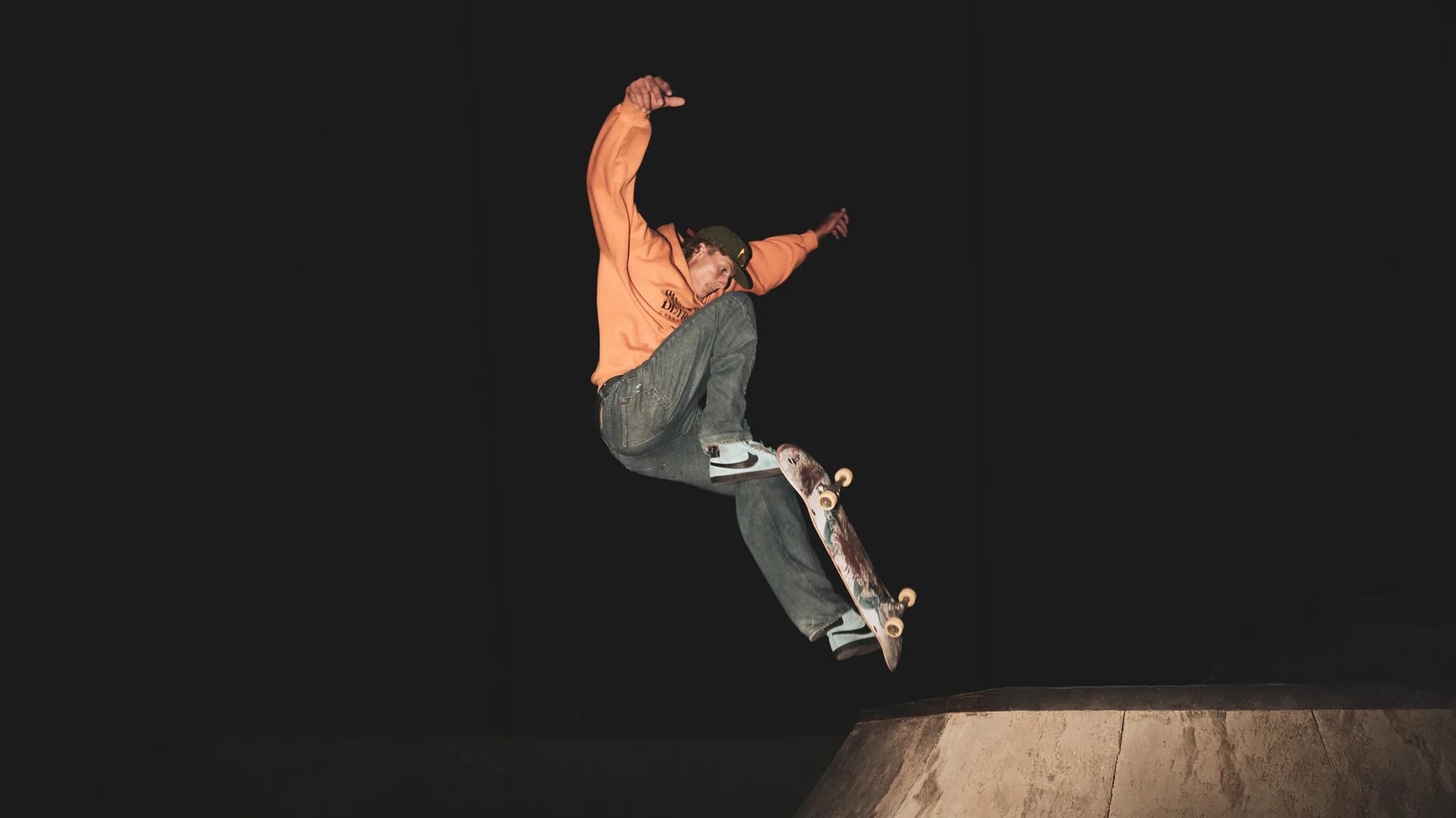 Skateboarder against black